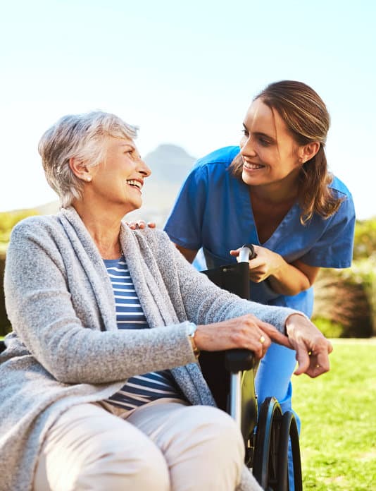 Caring nurse with elderly patient